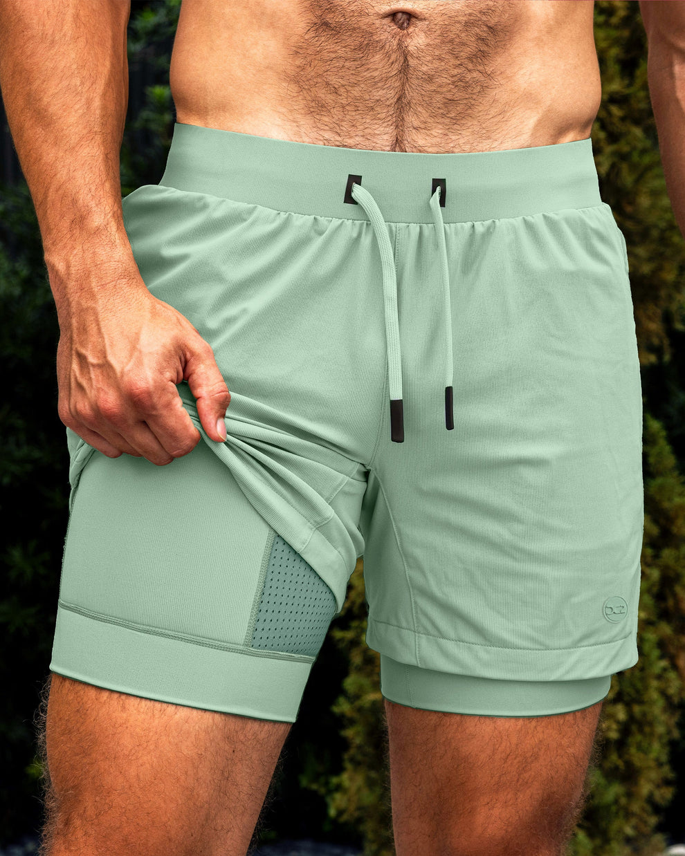BANG Miami Track Green Endurance 2-in-1 Gym Shorts — close-up of men’s sage green training shorts with built-in liner detail.