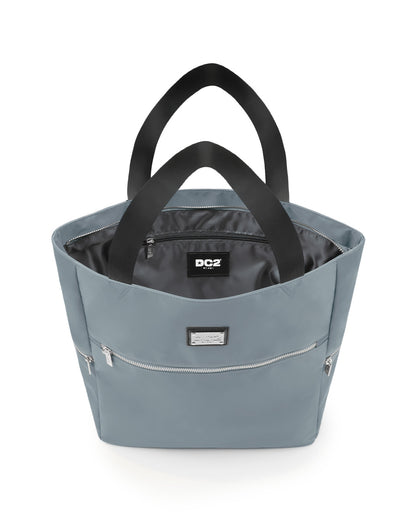 Top view of the VACAY GRAY Poolside Tote Bag by DC2 Miami, showcasing the spacious interior with a visible DC2 Miami logo label. The bag features a light grey color with sturdy black handles and multiple zippered compartments for secure storage.