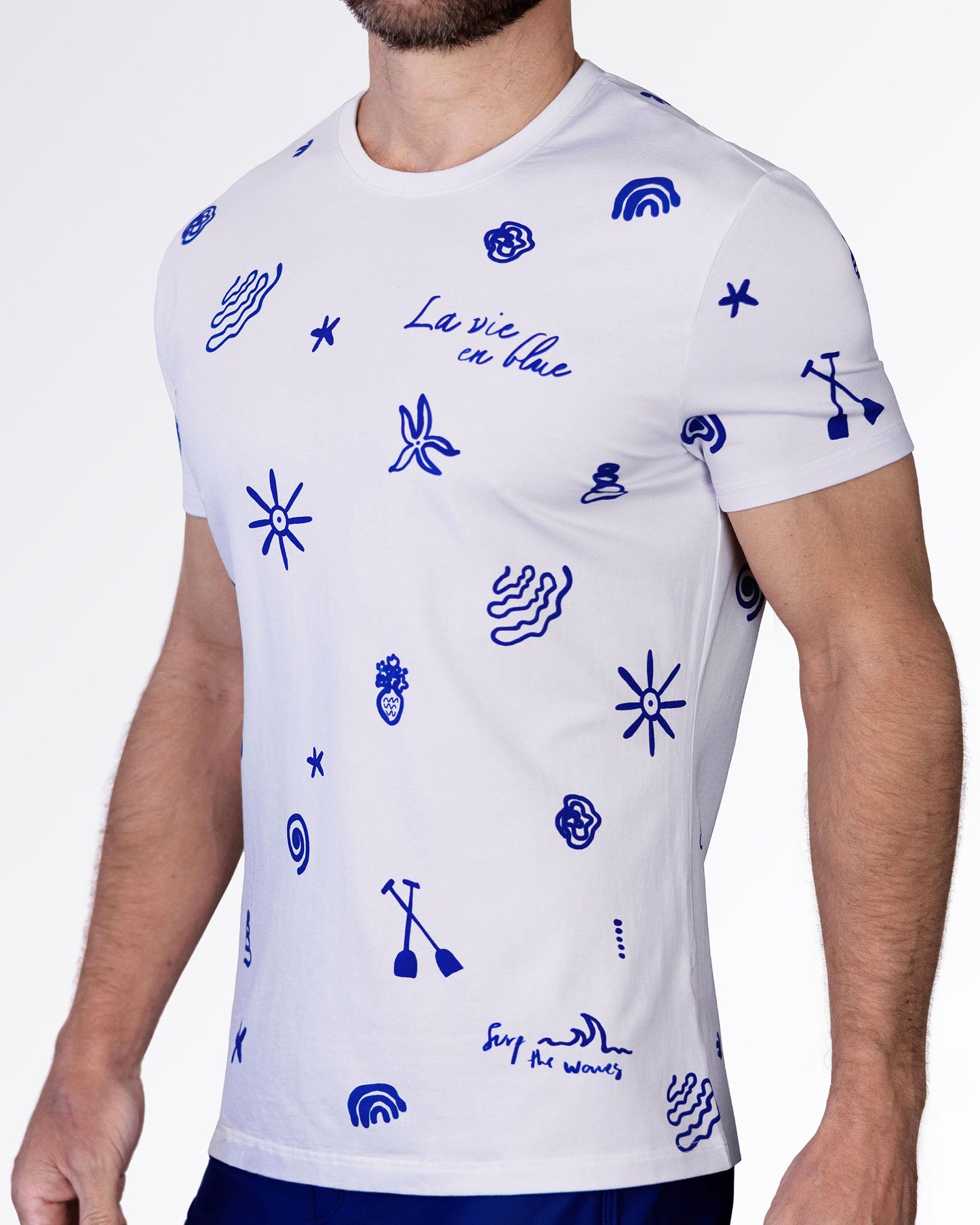 Side view of the Viva La Vida (Blue) cotton T-shirt with bold blue doodle graphics, crewneck collar, and fitted short sleeves.
