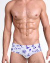 BANG! Viva La Vida (Blue) Swim Brief — front view featuring cobalt blue graphic illustrations and handwritten text on a soft white base with low-rise tailored fit.