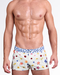 BANG Flower Powers (Cream) Mini Shorts — front view featuring a soft cream base with colorful scattered floral prints and a contrasting blue floral waistband for a fresh summer look.
