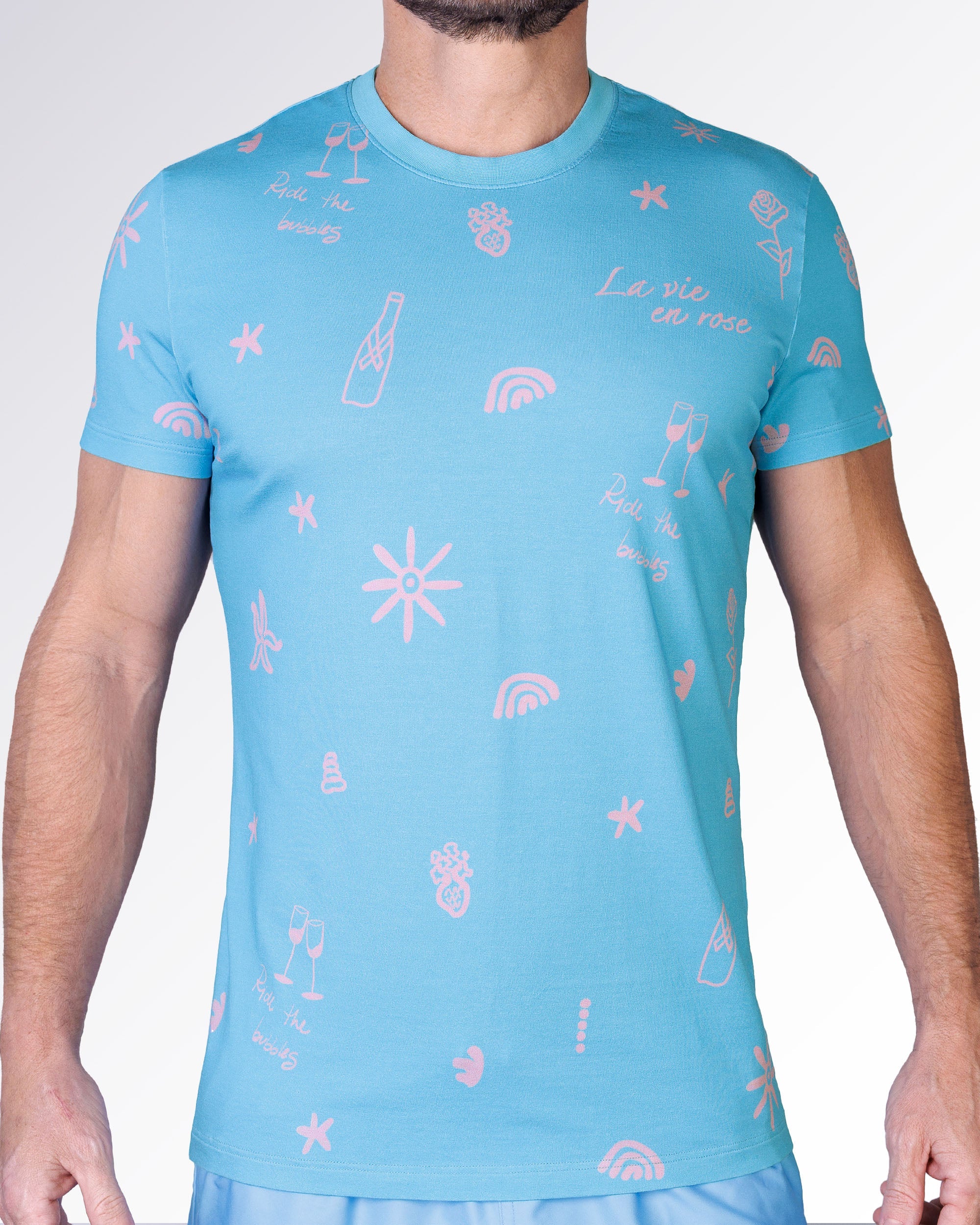 Viva La Vida (En Rose) Cotton Graphic T-Shirt by DC2 Miami featuring a sky-blue base with pink resort-inspired illustrations.