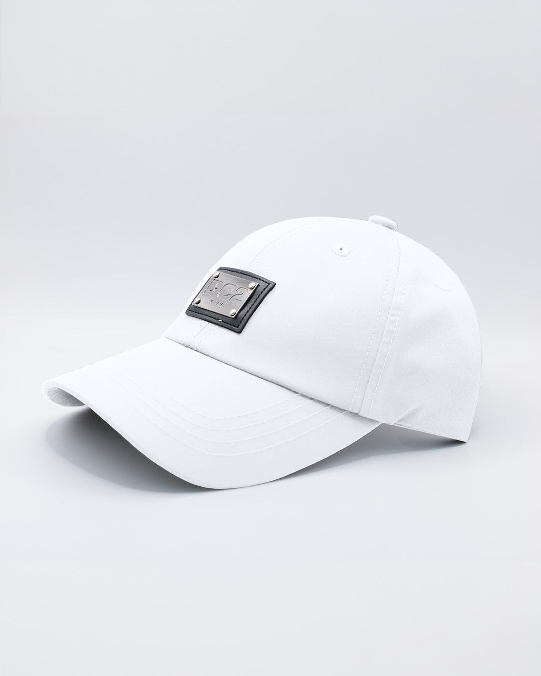 Close-up of a WHITE Baseball Cap with polished DC2 metallic silver plaque.