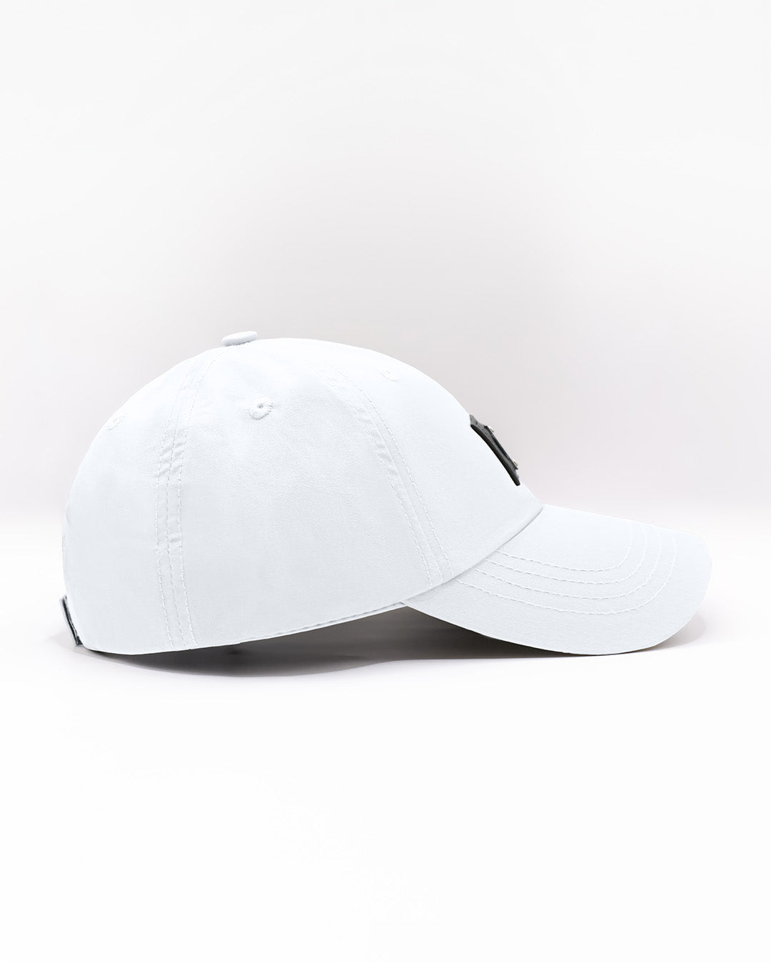 Side view of the WHITE Chillax baseball cap, showcasing its sleek and minimalist design. The cap features a solid white color, durable stitching, and a curved brim, perfect for casual and streetwear styles. Made for comfort and style, this dad hat is ideal for everyday wear, whether at the beach or on the streets.