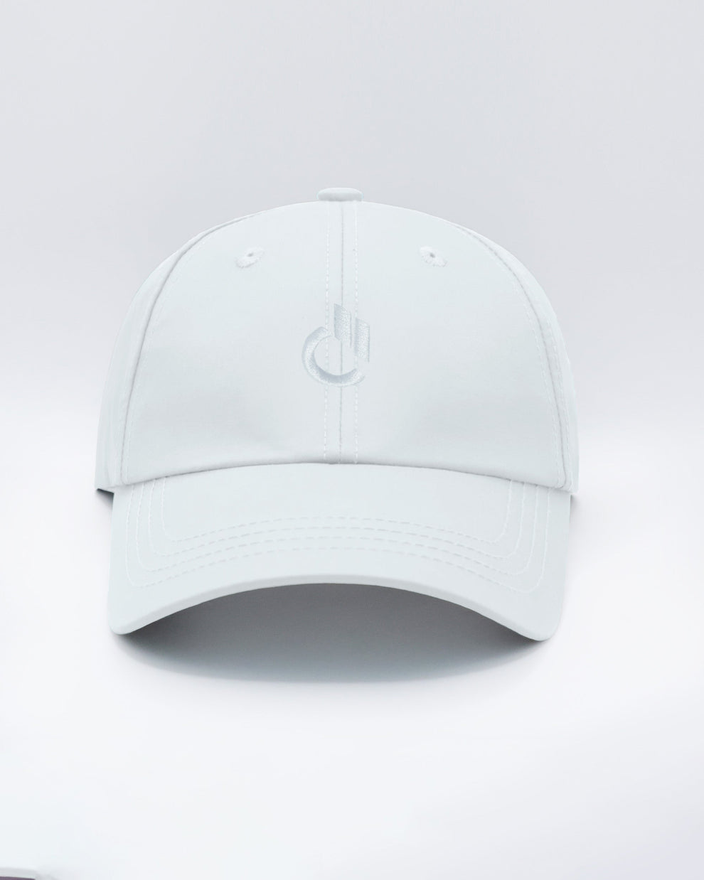DC2 Resort Cap in White — front view showcasing a curved brim, structured crown, and tonal embroidered DC2 logo.