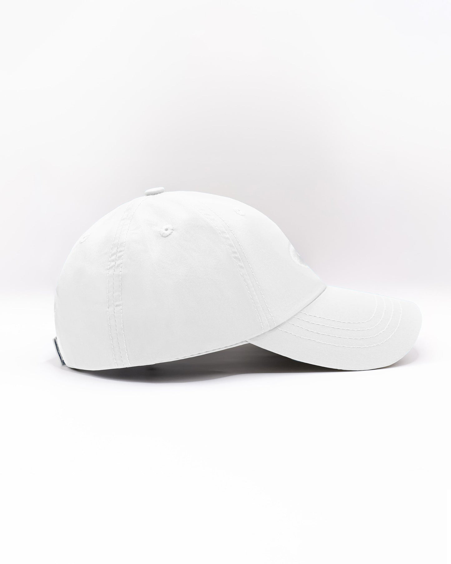 DC2 Resort Cap in White — side view showing the low-profile fit, curved brim, and smooth cotton twill finish.