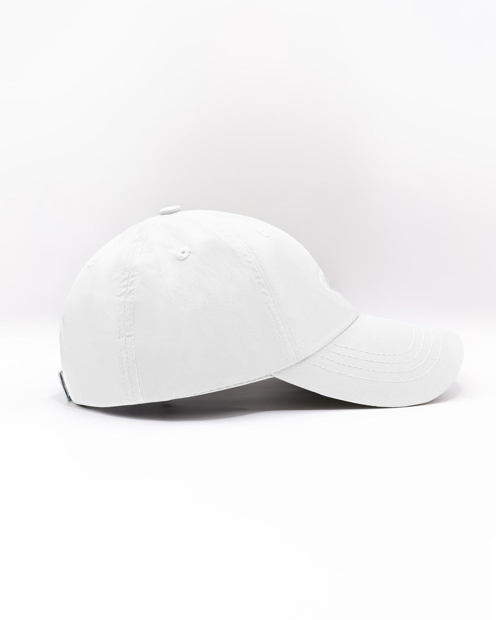 DC2 Resort Cap in White — side view showing the low-profile fit, curved brim, and smooth cotton twill finish.