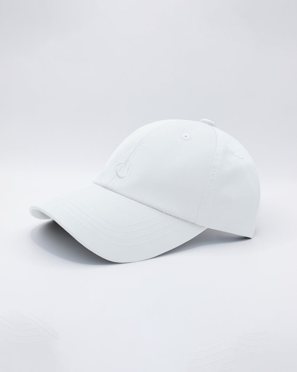 DC2 White Resort Cap — angled view emphasizing the curved brim, clean stitching, and minimal DC2 embroidery.